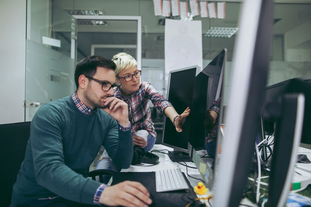 software-developers-at-work-962145656-5b69e9a546e0fb0050da5466-scaled